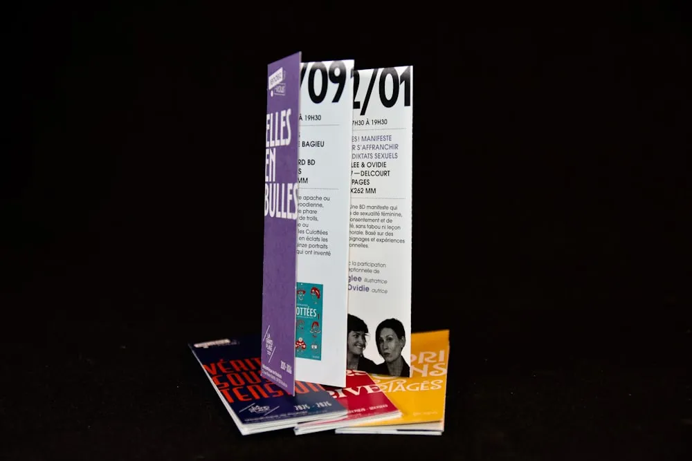 A stack of folded printed brochures