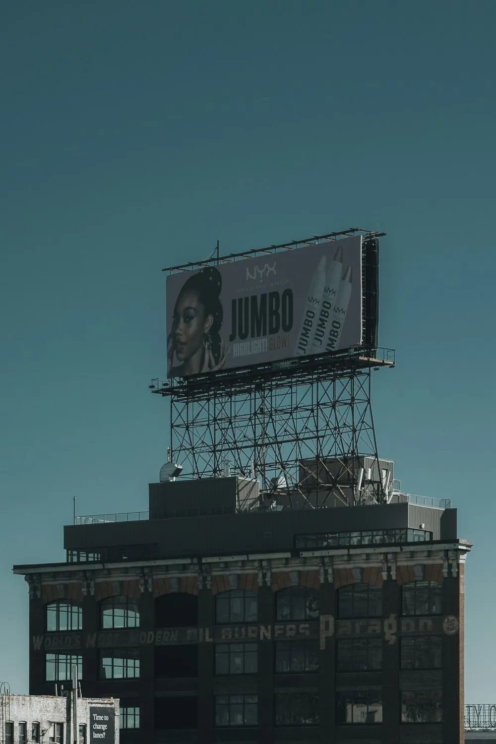 A large advertising billboard on top of a city building